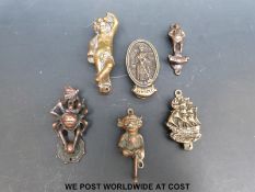 A small collection of brass / bronze door knockers including insect,