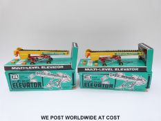 Two Britains Ltd model Hand Operated Multi-Level Elevators, both with yellow body,