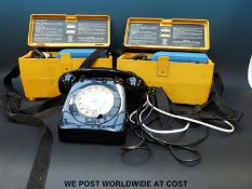 A 1960s party-line black telephone together with a pair of British Telecom test phones
