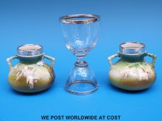A pair of twin handled small vases with silver rims,