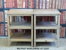 A pair of three tier occasional tables with cross frames,