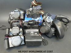 A box of mixed film cameras including Canon,