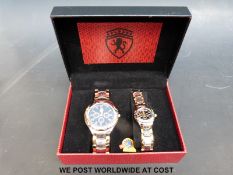 A pair of watches (his and hers) in a display case