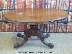 A mahogany oval topped breakfast table with carved four legged base (max diameter 133,