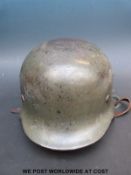 A WWII German SS helmet stamped ET66 and 3683 to inner rim