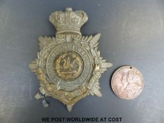 A 1937 coronation medal and South Wales Borderers badge.