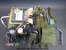 A small collection of Action Man outfits and accessories to include two combat uniforms, guns,