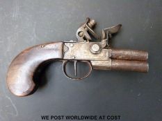 Double barrelled over and under tap-action muff pistol with silver wire inlaid and chequered shaped