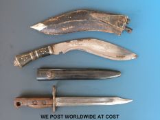 A short bayonet in scabbard and a similar sized kukri