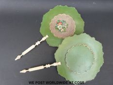 A pair of ivory handled pressed paper face screens