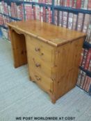A pine desk with three drawers to one side (W100 D44 H75cm)