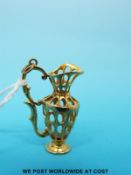 A 9ct gold charm in the form of a ewer (5.