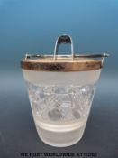 A plated and cut glass ice bucket and tongs