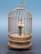 A small automaton clock in the form of a bird in a cage, the bird moving as the clock ticks,