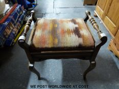 An upholstered mahogany piano stool