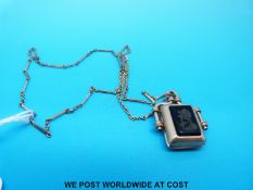 A Victorian locket set with moss agate to one side and a carved onyx ingot to the other,