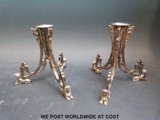 A pair of silver plated Egyptian style candlesticks or vase bases, height 10.