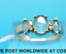 A yellow metal ring marked 14k set with topaz and diamonds,