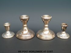 Two pairs of hallmarked silver squat candlesticks,