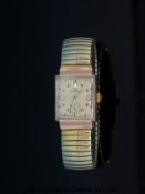 Longines 14ct gold ladies wristwatch with two round cut diamonds and a baguette cut diamond set to