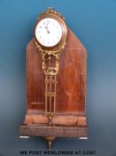 A pendulum clock in decorated metal floral and foliate case,