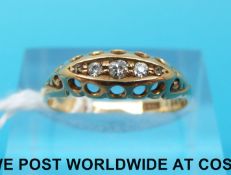 A yellow metal ring marked 18ct set with five diamonds (size W)