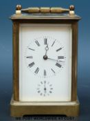 A brass carriage clock in original carry case,