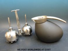 A Gregory Jensen thermos together with a modern oil and vinegar set.