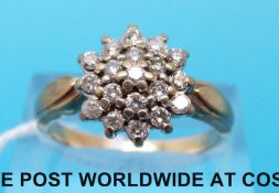 A yellow metal ring marked 9ct set with diamonds in a cluster (size P)