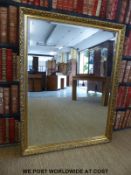 A large gilt framed mirror with bevelled glass (100cm x 128cm overall)