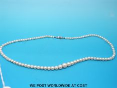 A cased string of graduated pearls with 9ct gold and diamond clasp