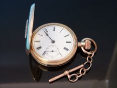 A gentleman's gold plated half hunter pocket watch on short gold Albert chain,