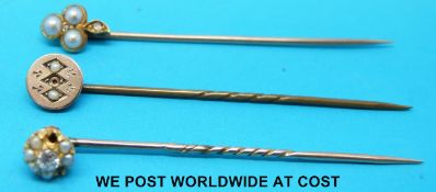 Three yellow metal stick pins set with seed pearls and diamonds