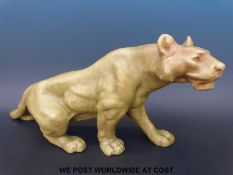 A Czechloslovakian ceramic model of a lion in the style of Royal Dux (25cm tall,