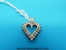 A 10ct gold pendant set with diamonds in a heart shape,