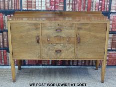 A Waring & Gillow Ltd Art Deco burr walnut sideboard with three fitted drawers flanked by a