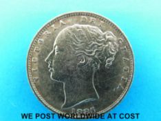 An 1885 gold full sovereign young head, shield reverse,