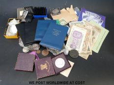 A collection of mixed coins and bank notes to include £1 notes, £2 coins and copper coinage.