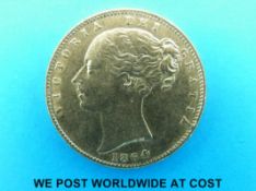 An 1864 young head gold full sovereign, shield reverse,