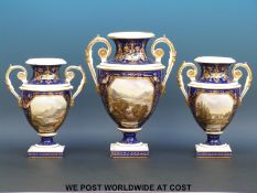 A Bloor Derby porcelain garniture comprising three twin handled pedestal vases,