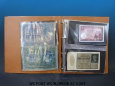 An album containing a collection of overseas banknotes, to include Russia, Bahamas,