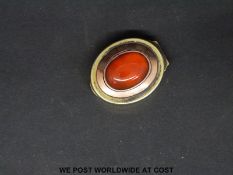 A Georgian gilt metal and gold vinaigrette with with carnelian cabochon,