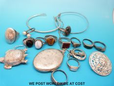 Eleven silver rings variously set with pearls, agate, tigers eye etc, silver locket,