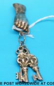 A hallmarked silver brooch in the form of a hand holding keys