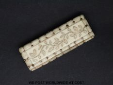 A 19thC gold inlaid carved ivory patch box with mirror, length 6.