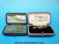 A yellow metal brooch, marked 15k, set with a ruby,