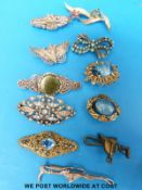A collection of brooches to include two filigree, silver and paste, miracle etc.