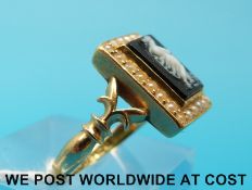 An 18ct gold Victorian ring set with an onyx cameo surrounded by seed pearls (size P)