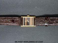 Baume and Mercier 18ct gold ladies wristwatch with gold hands and tigers eye face on brown