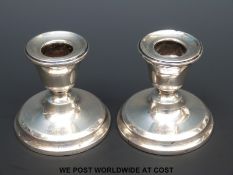 A pair of hallmarked silver dwarf candlesticks,